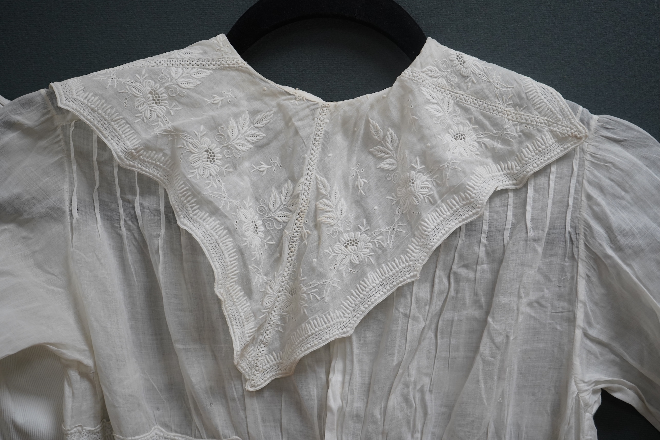 Two late 19th early 20th century girls summer dresses, one fine cotton with white worked collar cuffs and bodice, the other a cotton twill with anglaise collar large puff sleeves and gathered across the chest, lawn dress